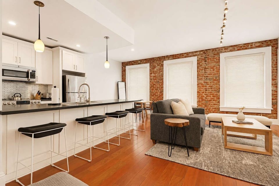 The living room with its natural lighting offers a perfect place to watch a movie with family and friends.