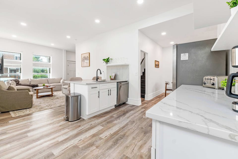 This stunning kitchen with white cabinets and warm hardwood floors is the perfect backdrop for cozy brunches and culinary adventures. Imagine whipping up your favorite meals while soaking in the serene vibes.