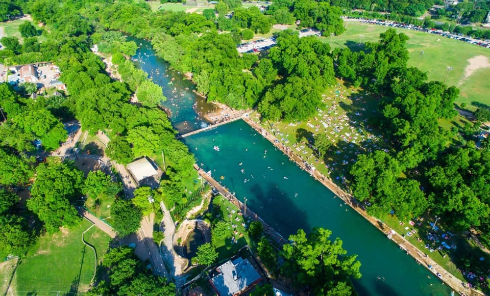Barton Springs Pool is a three-acre underground spring-fed pool that remains at a constant temperature year-round, located within Zilker Park.