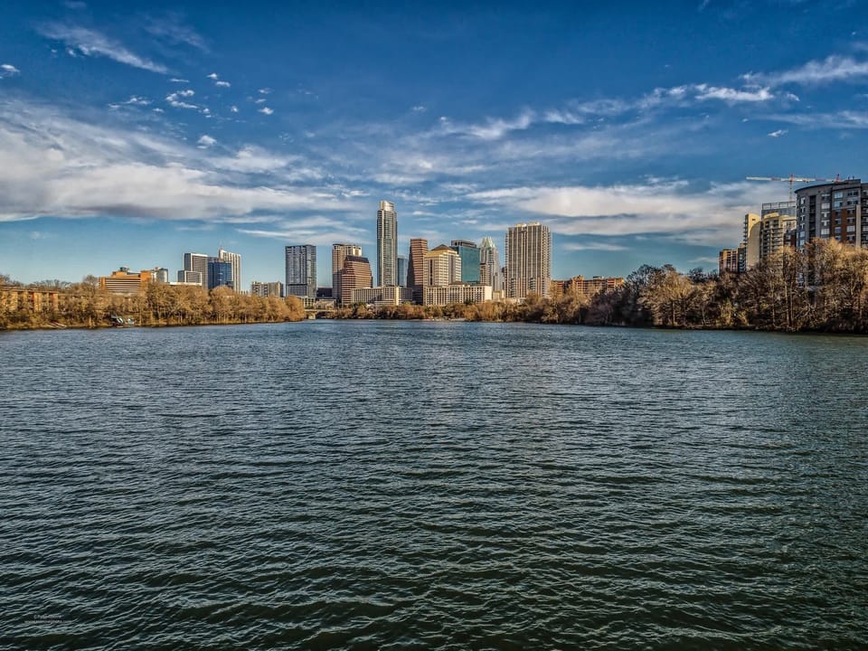 Lady Bird Lake offers the iconic view of the Austin skyline and is the city's primary hub for paddleboarding and kayaking.