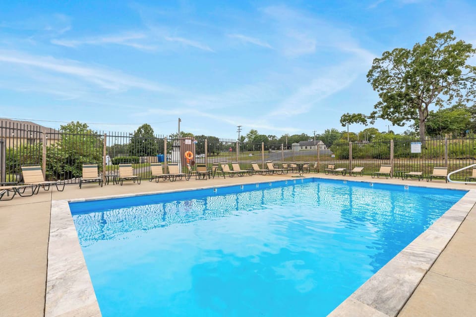Shared resort pool with reclining poolside chairs