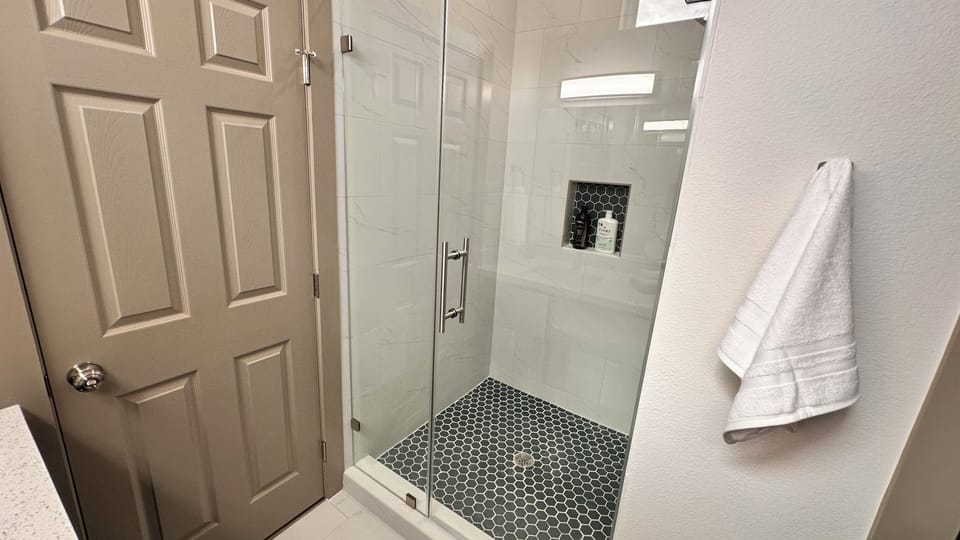 Master bathroom with a large shower and two sinks