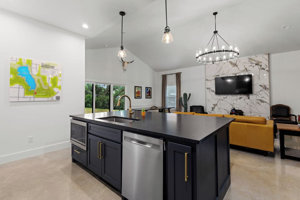 From the kitchen, enjoy a clear view of the open living room and 65" Roku HDTV. 