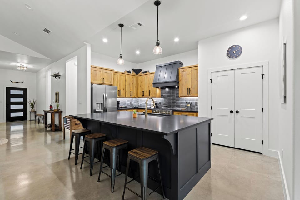 Spacious kitchen and oversized island, fully stocked for cooking and dining.