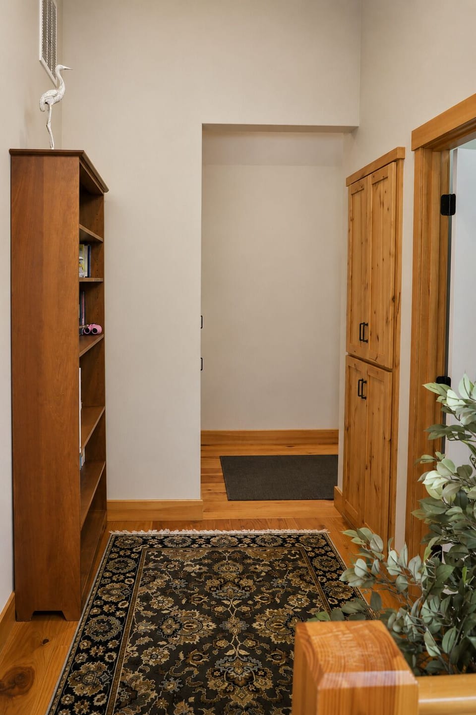 Step into your warm entryway where rich wood tones, cozy touches, and thoughtful storage set the tone for your home away from home.