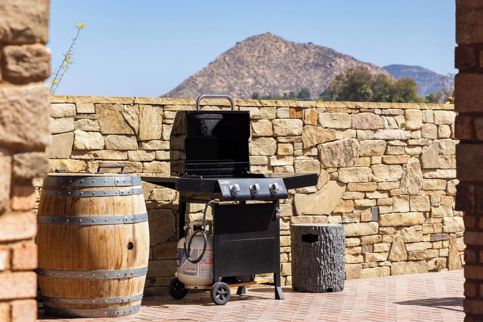 Fire up the grill on the stone patio, with rugged mountain views creating a scenic backdrop for outdoor cooking.