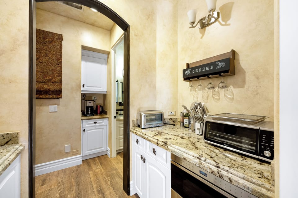 A convenient butler’s pantry adds extra prep space, countertop appliances, glassware storage, and a dedicated coffee station.