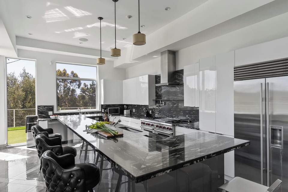 Sleek design meets gourmet functionality in this stunning, modern kitchen.