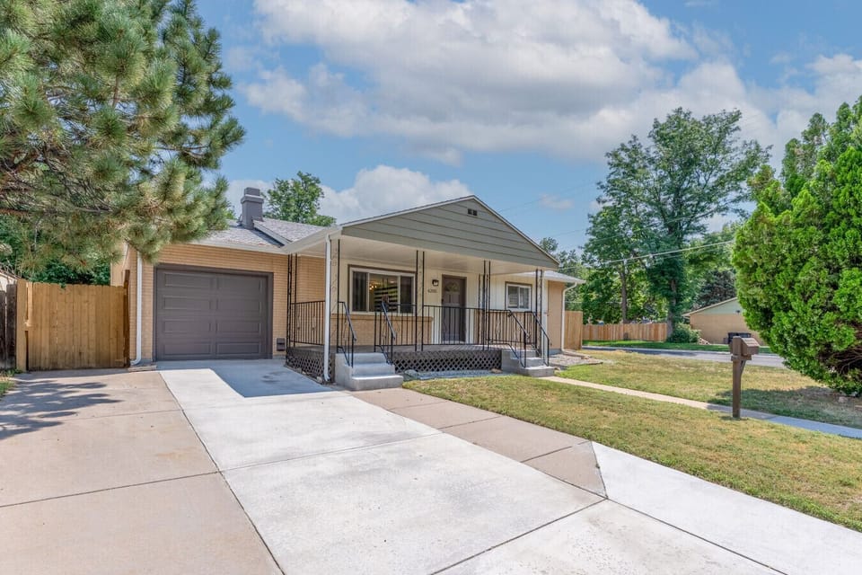 Exterior of home with spacious driveway and plenty of parking