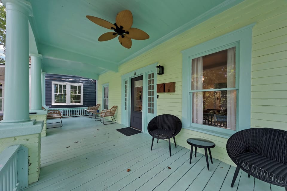 Relax on the breezy covered porch w/ ceiling fan, rocking chairs & soft pastel tones