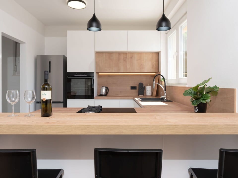 Furniture, Kitchen, Interior Design, Countertop, Flooring, Wall, Cabinetry, Wood, Light Fixture, Kitchen Appliance