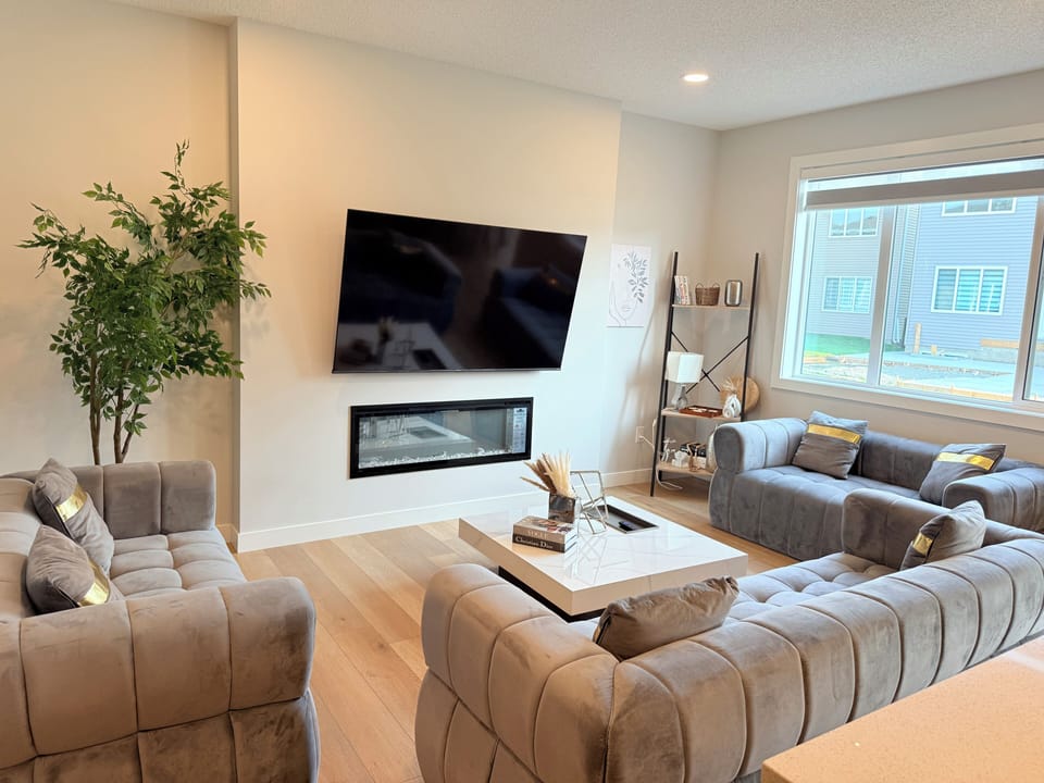 Spacious living room with 3-3-2 cozy sofa seater — perfect for large groups to relax and enjoy the 70” TV