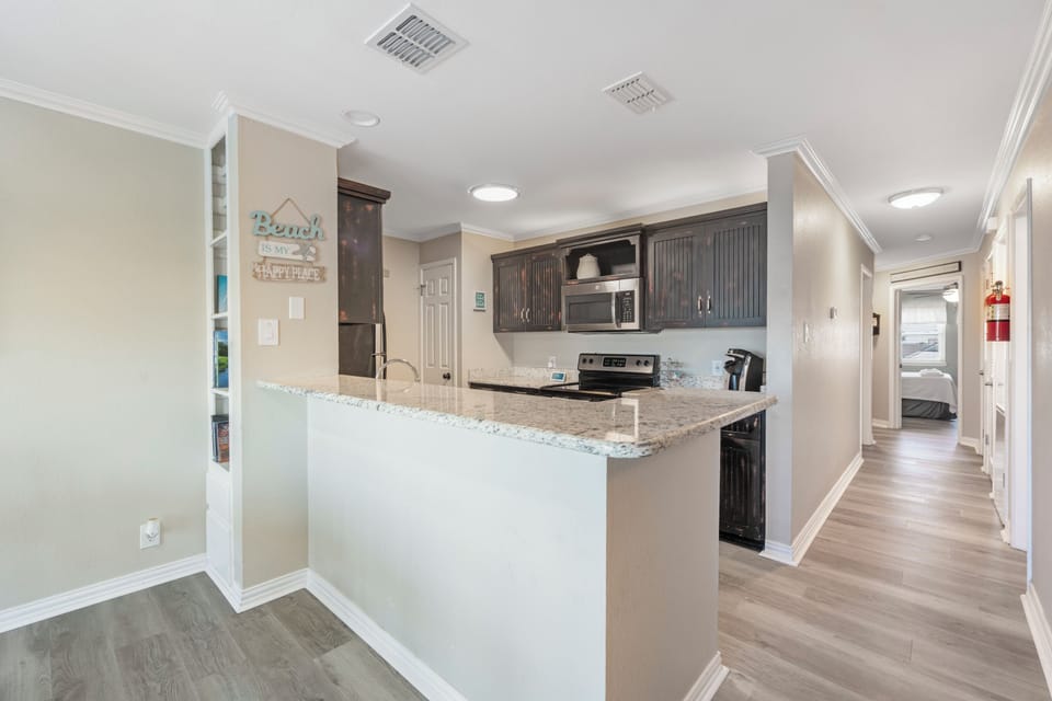 Your fully equipped kitchen features granite counters and modern appliances, perfect for preparing meals during your stay.