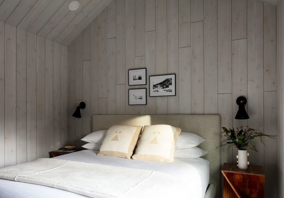 Drift off beneath warm wood walls and soft bedside lighting.