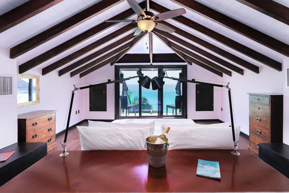 Wake up to ocean views beneath soaring, beamed ceilings.