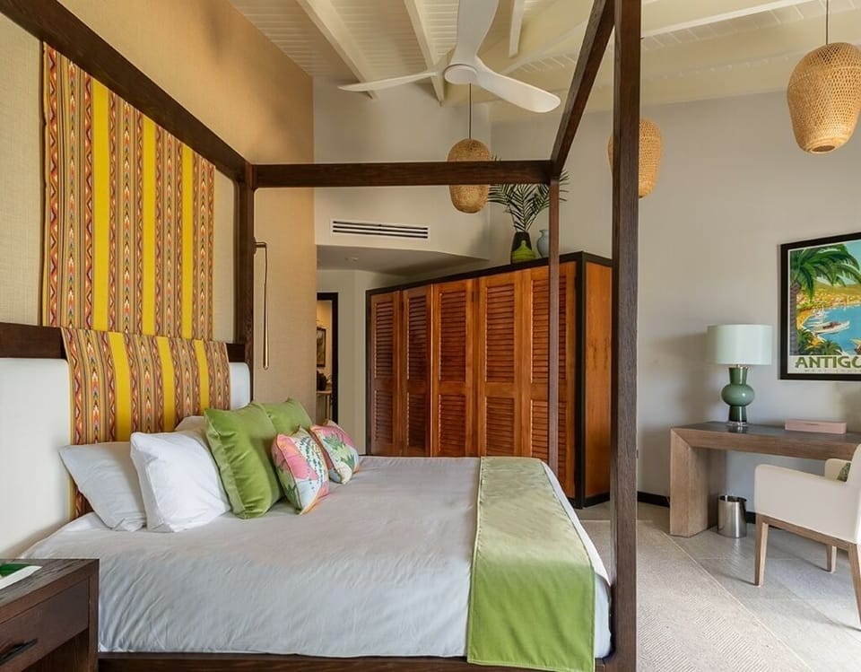 Sink into a romantic canopy bed with island-inspired charm.
