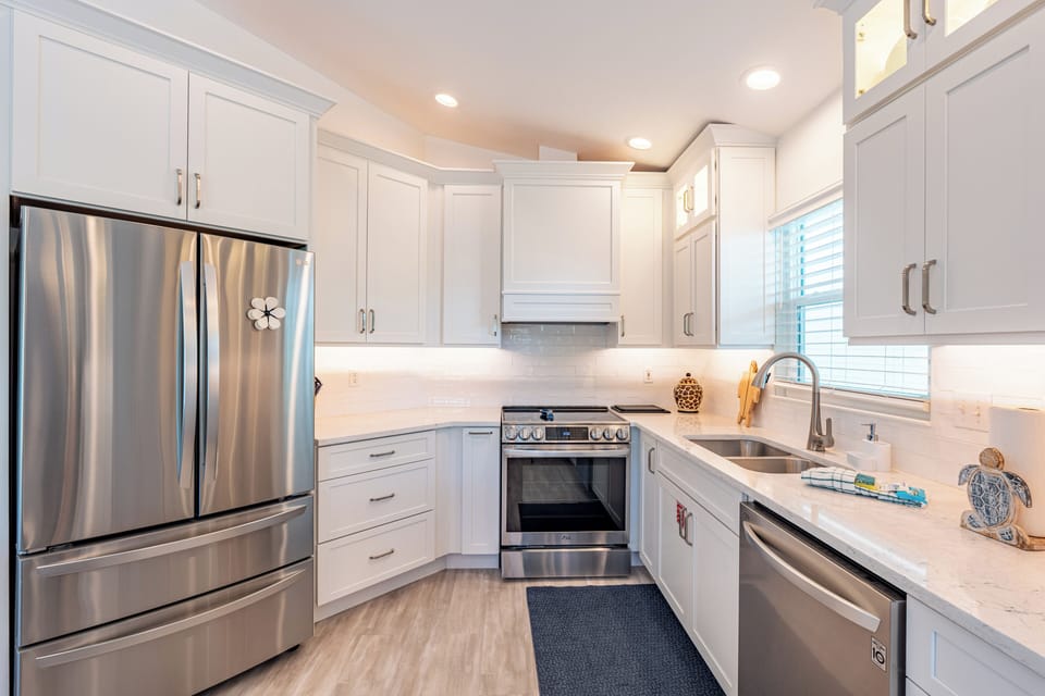 Bright cabinets, sleek finishes, and beachy touches throughout.