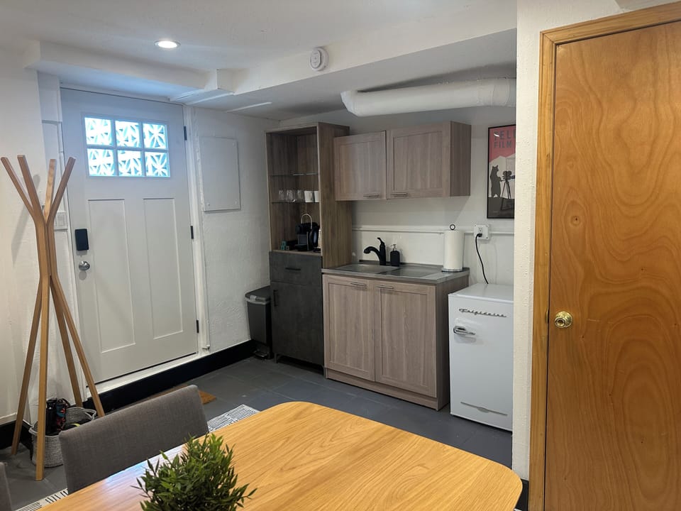 Entry room with bar sink, mini-fridge,, tea, and Nespresso pods.