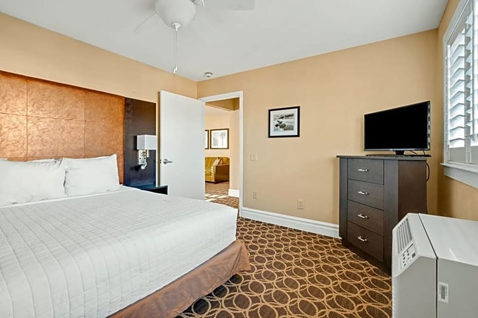 Enjoy a roomy bedroom setup with dresser storage and TV.