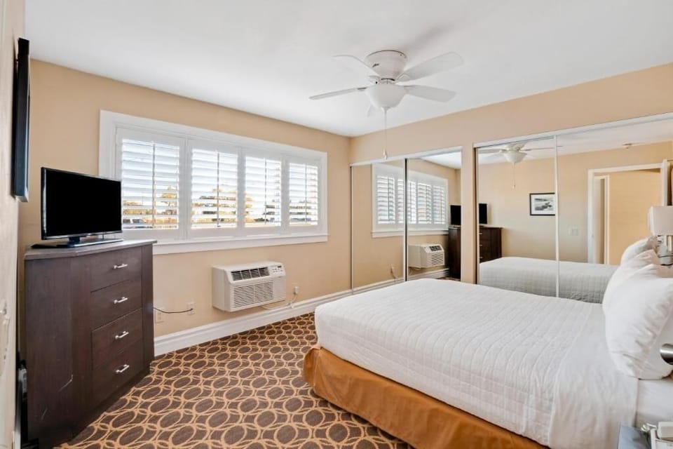 Stretch out in a sunlit bedroom with expansive mirrored closets.