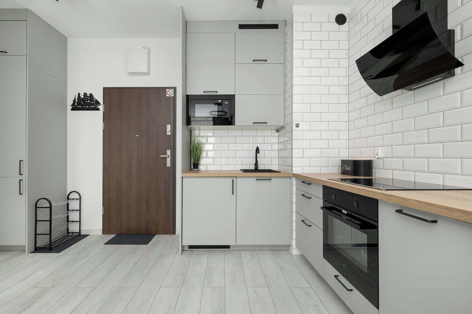 The sleek design of the kitchenette blending seamlessly with the living area.