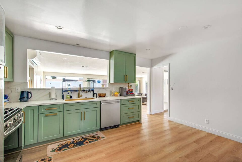 Fully stocked with utensils and cooking supplies, stainless steel appliances