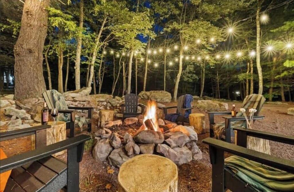 Woodland firepit with string lights for unforgettable nights.