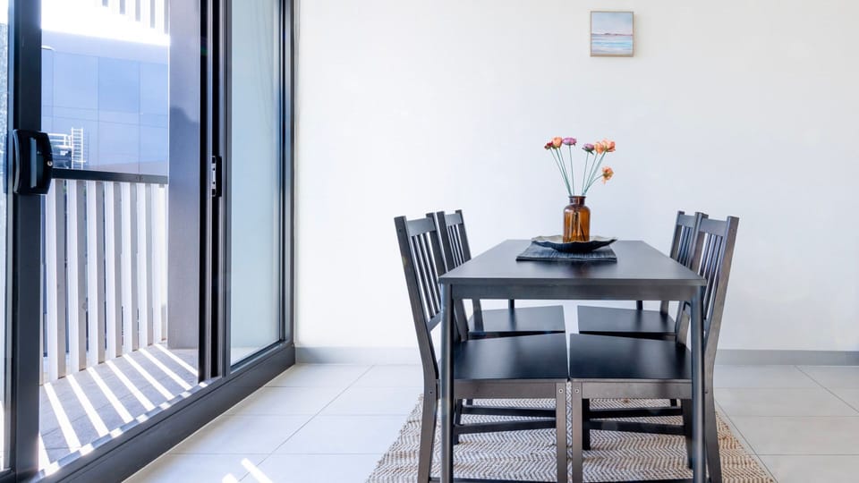 Intimate dining nook by the window, ideal for morning coffee moments.