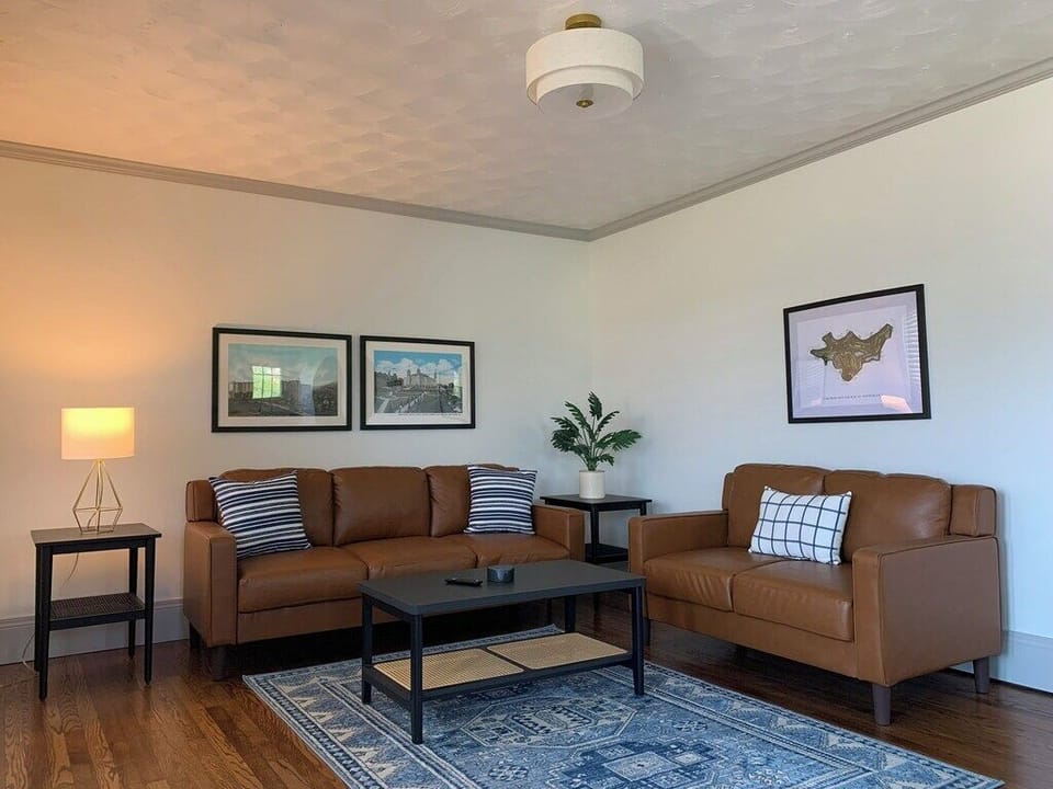 Spacious, stylish living room with all new furnishings, lighting, and decor.