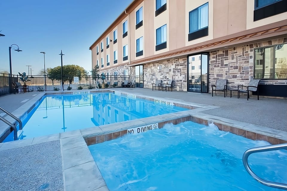 Unwind in the bubbling hot tub beside the sparkling pool.