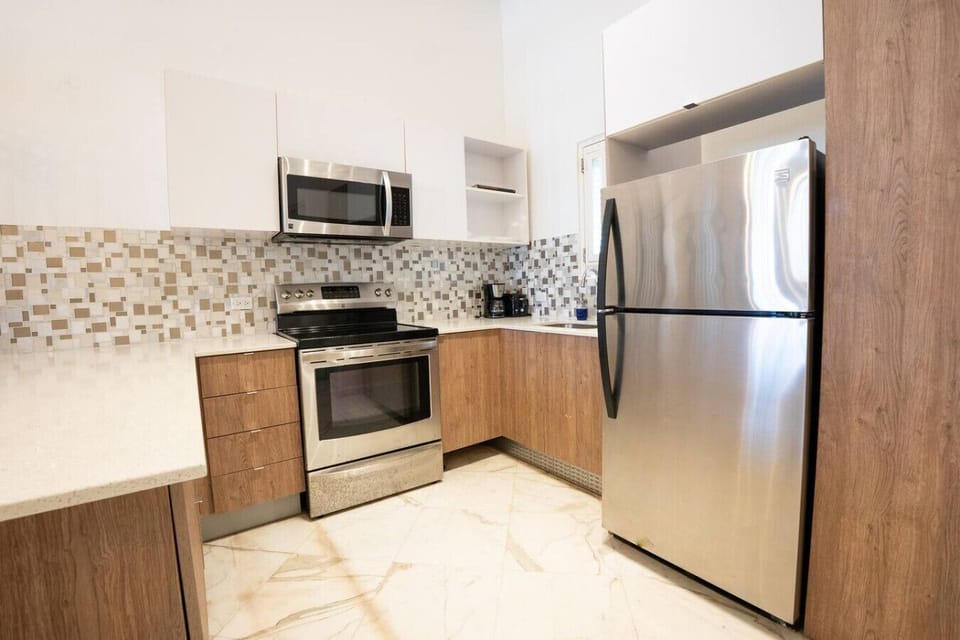 Fully equipped kitchen with stainless steel appliances and sleek finishes.