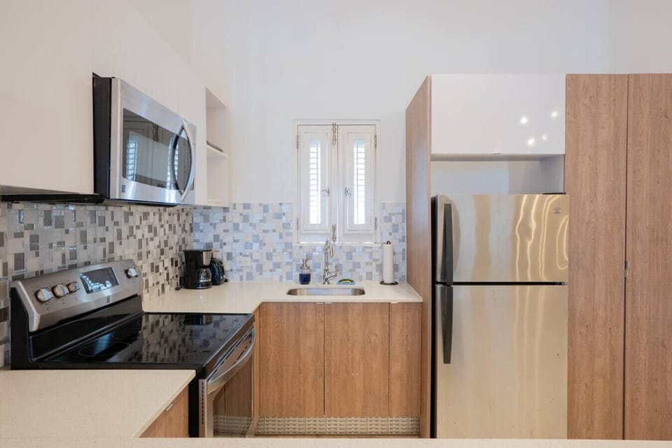 Compact kitchen with modern appliances and functional layout.