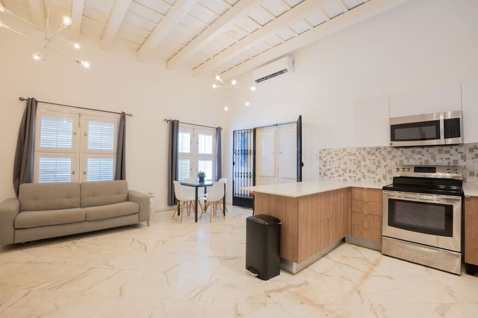 Bright open-concept space with kitchen, dining, and living areas.