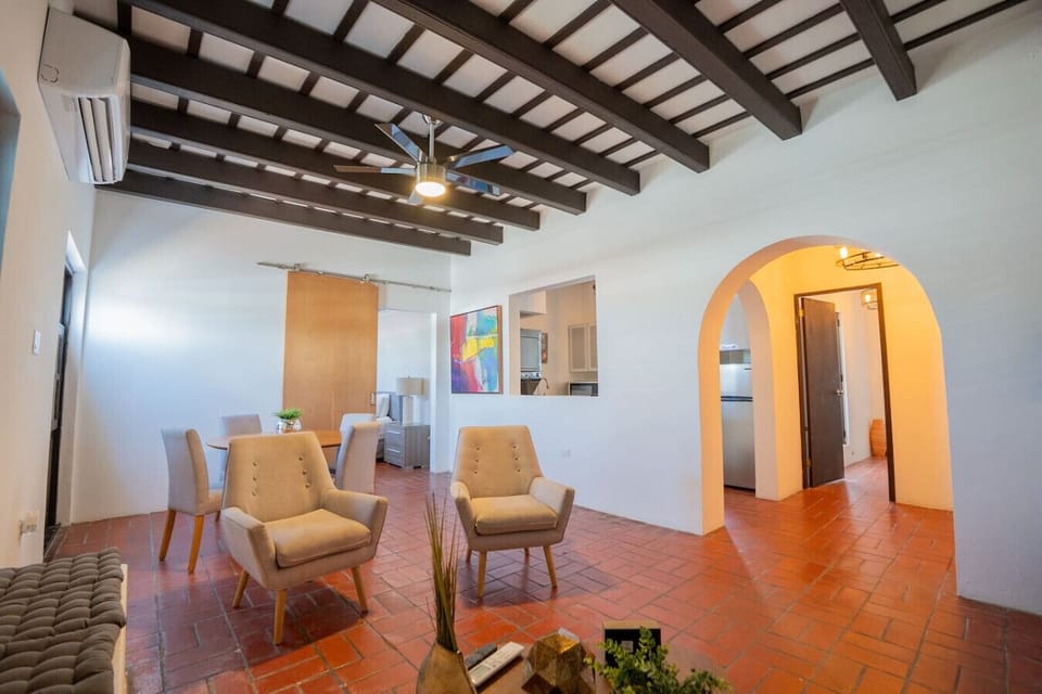 Open layout with dining area and exposed beam ceiling