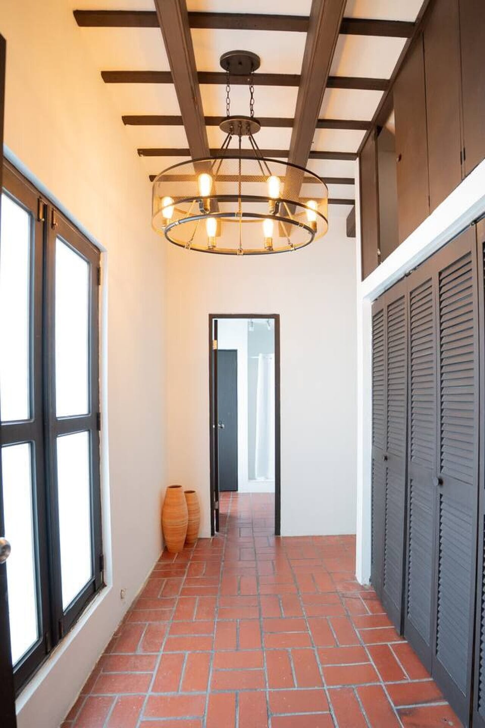 Bright hallway with modern lighting and rustic details