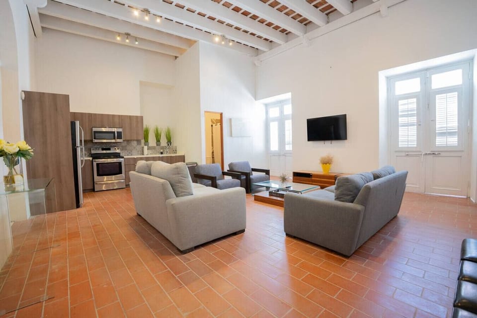 Spacious open-concept living with high ceilings and tile floors