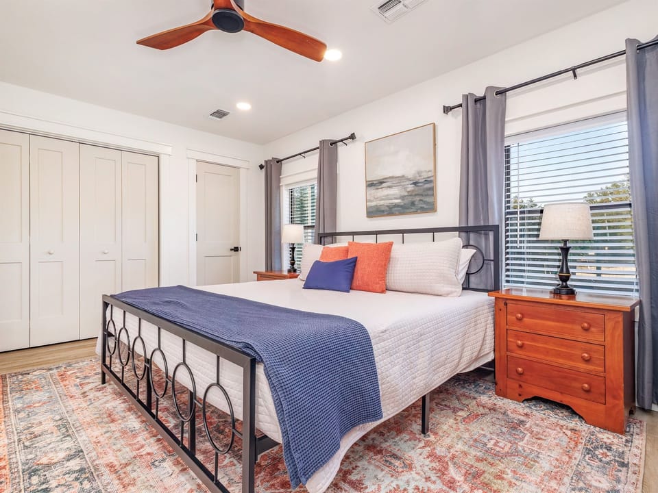 Downstairs master bedroom with a plush king bed, cozy linens, and plenty of storage for a comfortable stay.