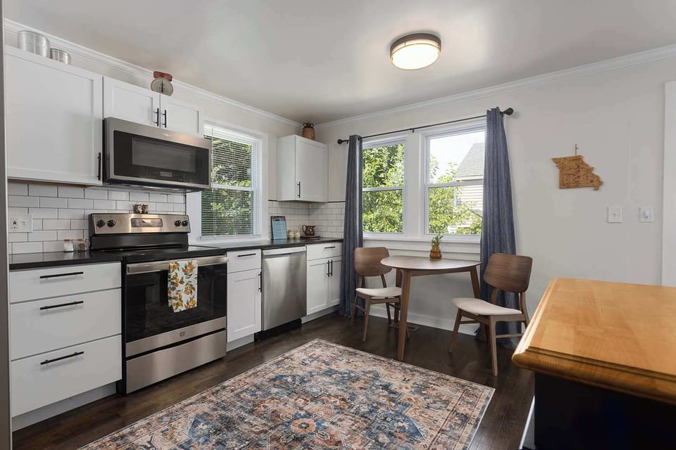 Full kitchen with stainless steel refrigerator, electric stove, dishwasher and microwave/convection oven. New granite countertops and an island for additional space make this kitchen fully functional. Cleaning supplies under kitchen cabinet. 