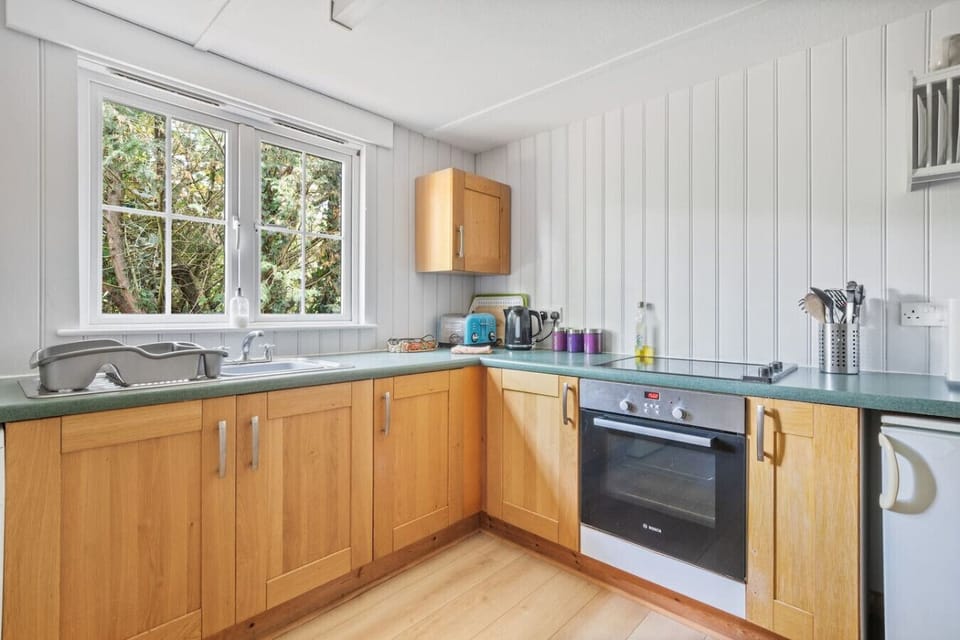 Modern kitchen with oven, hob, and appliances