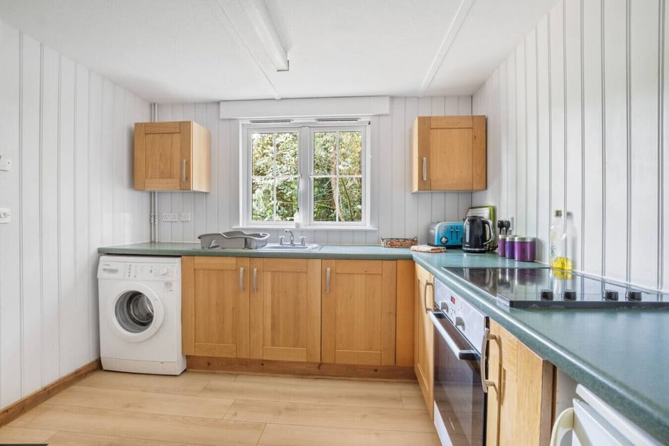 Fully equipped kitchen with woodland views