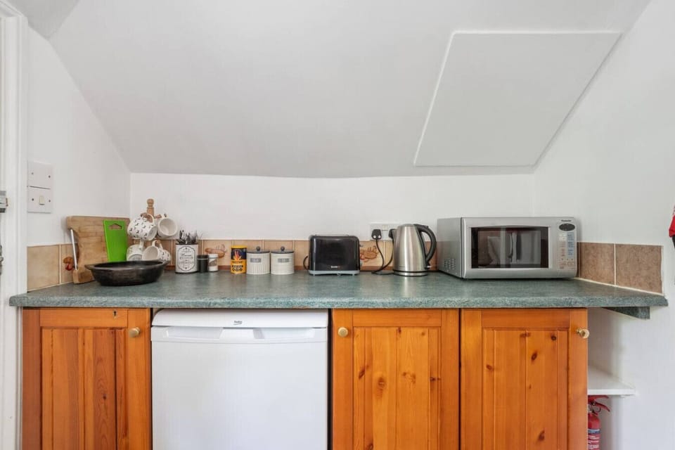 Kitchen essentials including microwave, kettle and toaster
