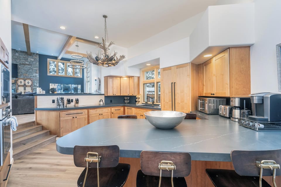 Your gourmet kitchen features a spacious island with seating, modern appliances, and an open design perfect for cooking and gathering with family.