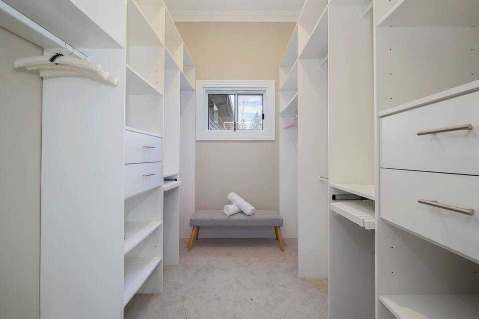 Keep your space clutter-free with the full walk-in wardrobe in the primary suite, offering plenty of room to store your belongings neatly.