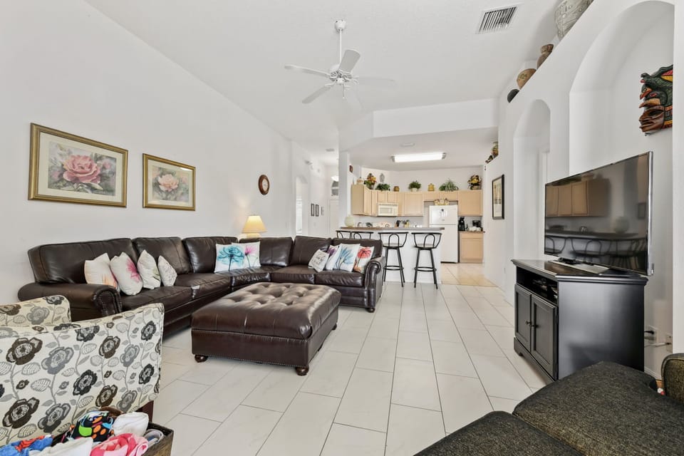 LIVING ROOM:  50” Flat Screen TV, Ceiling Fan and Direct Access to Pool/Patio Area