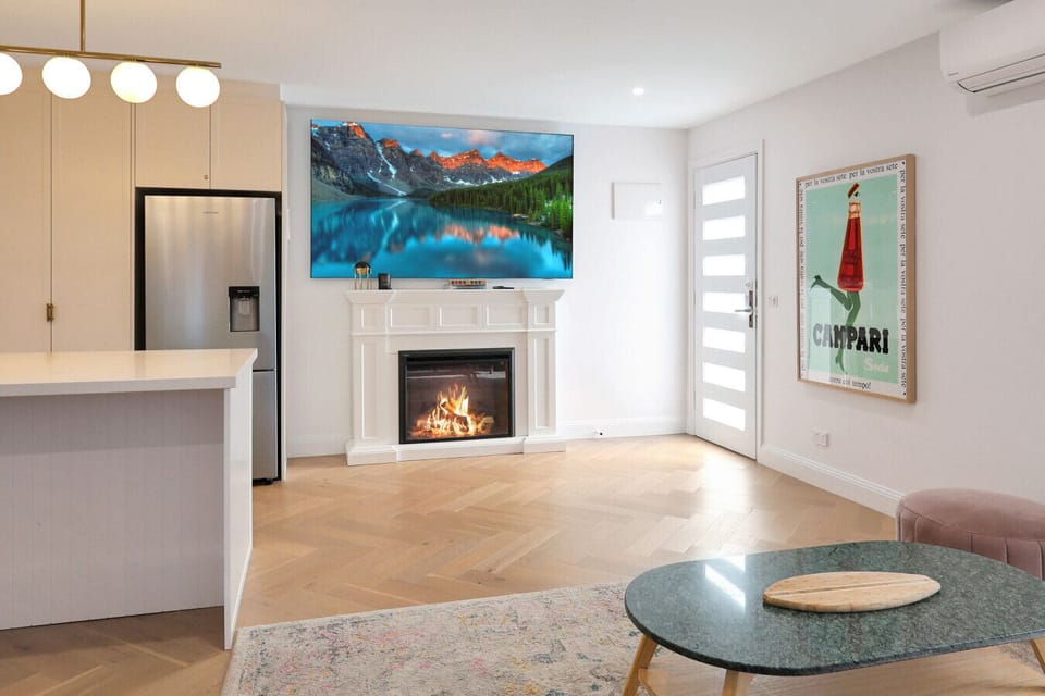 Bright living area with fireplace, smart TV, and open-plan layout