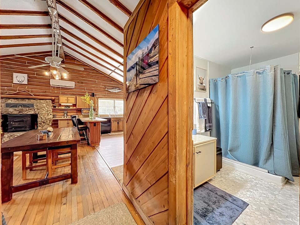 Rustic Living Area | Stone Fireplace & Wood Accents | Open Kitchen & Dining | Full Bathroom Nearby