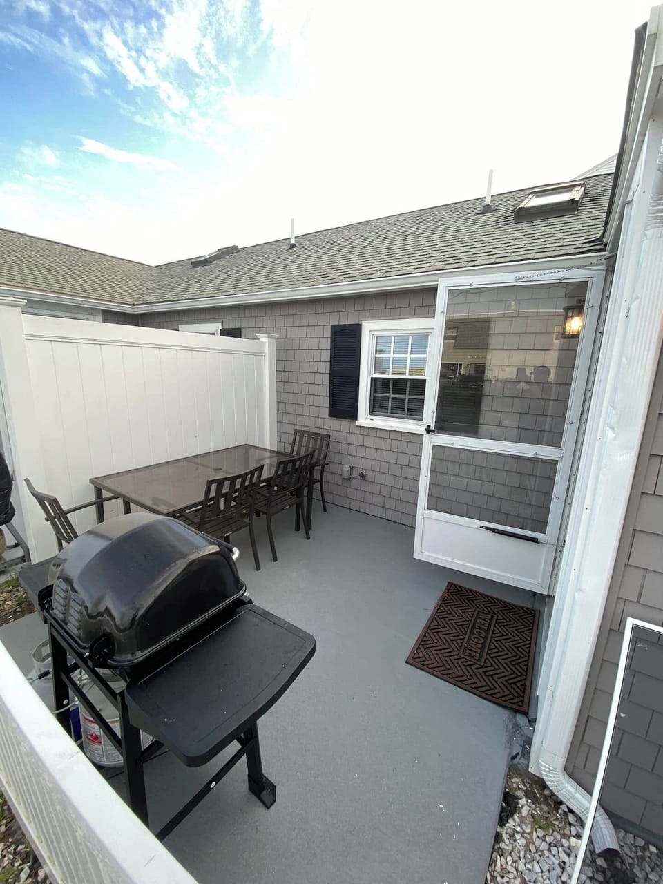 Private patio with seating and gas grill