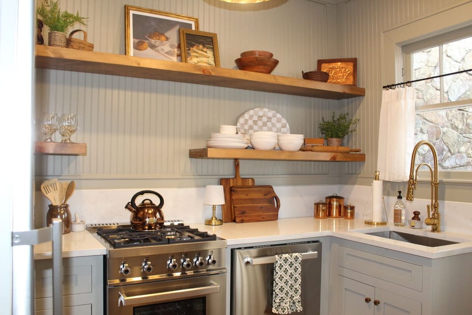 Fully equipped kitchen with vintage recipe box/cookbooks.