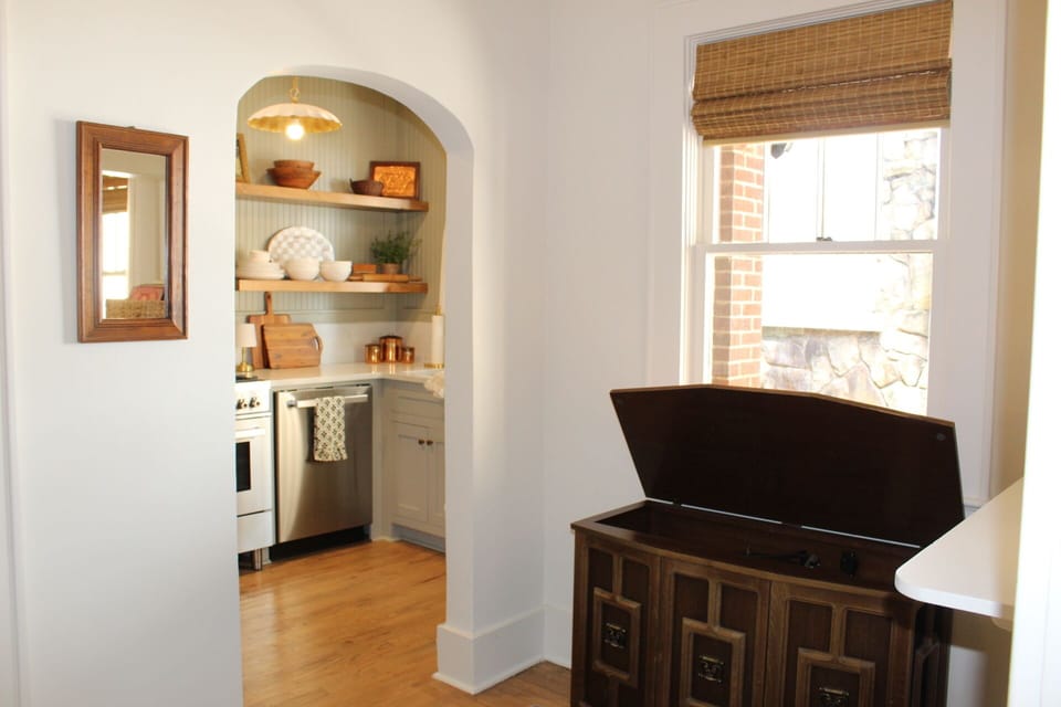 Vintage cabinet with working record player, 8-track, and radio adds retro charm.