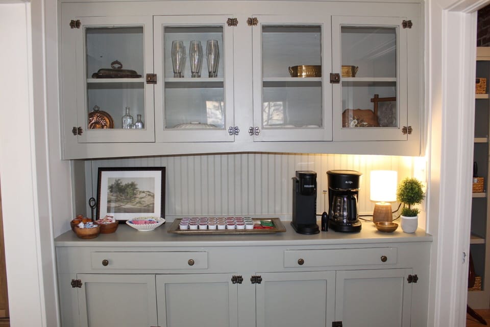 Coffee bar stocked with a variety of coffee, tea, sweetener, and creamer.